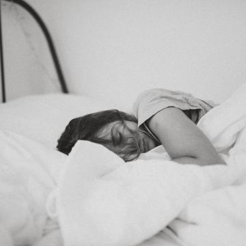 Woman unwell in bed